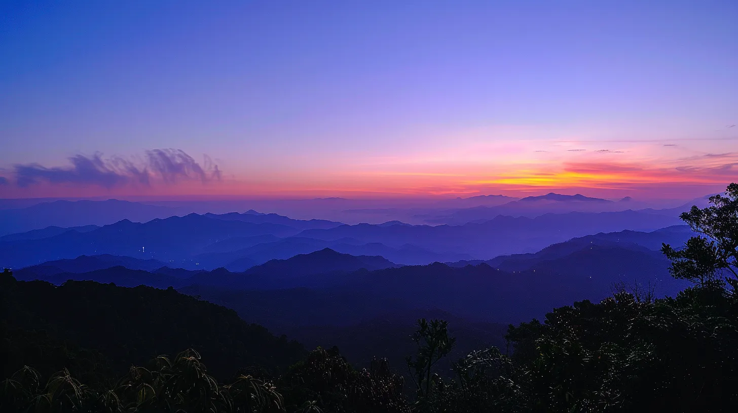 a breathtaking sunrise casts vibrant hues of orange and pink over a serene mountain landscape, highlighting the rugged peaks that tower majestically against the clear blue sky.